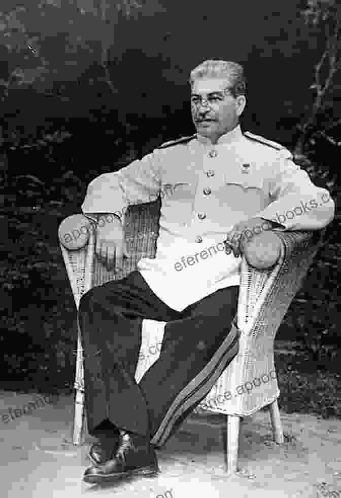 A Photograph Of Joseph Stalin, Wearing A Suit And Tie, Sitting Behind A Desk In A Dimly Lit Room Stalin S American Spy: Noel Field Allen Dulles And The East European Show Trials